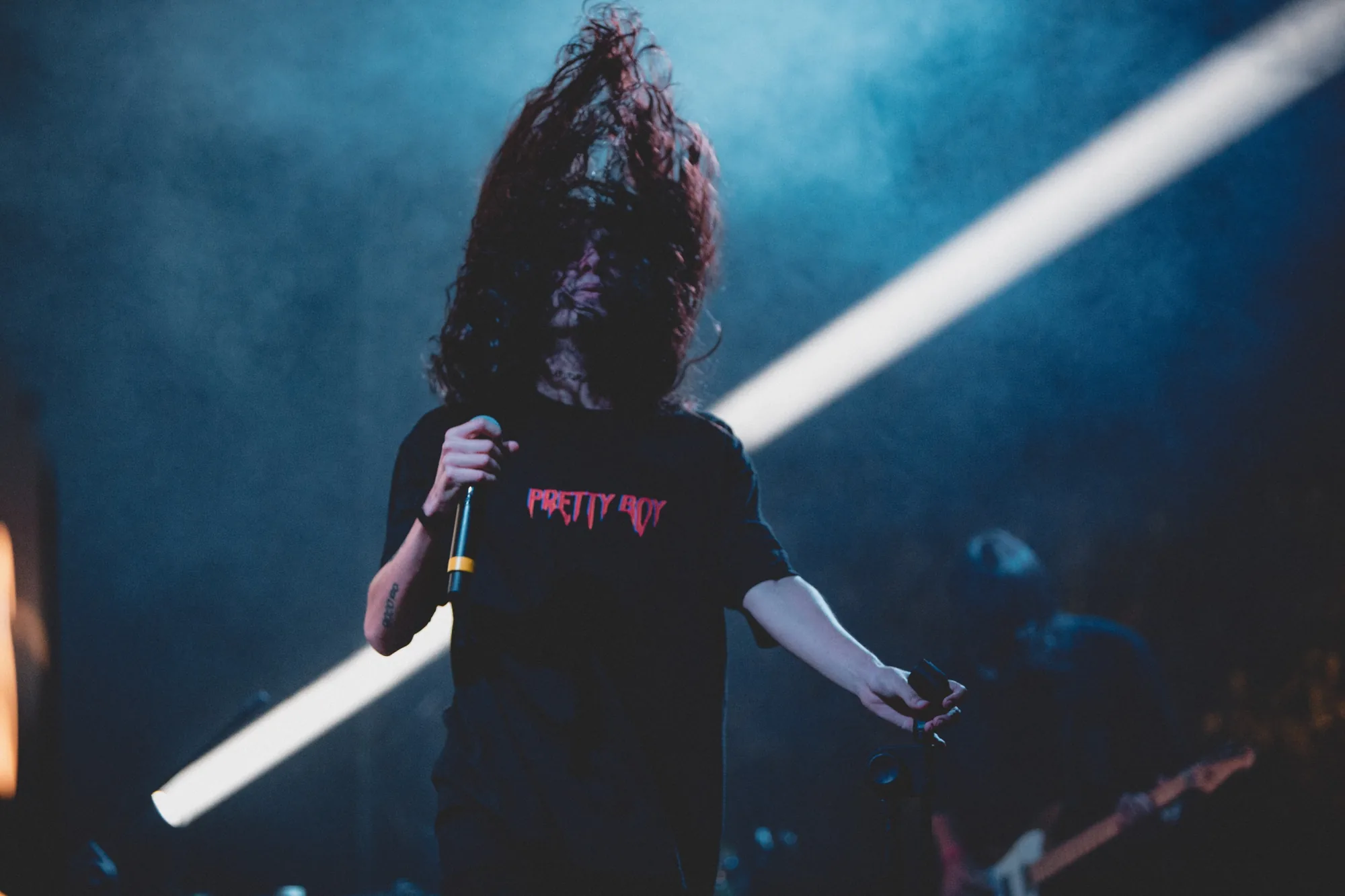 Vipra in concerto, capelli in movimento e fascio di luce